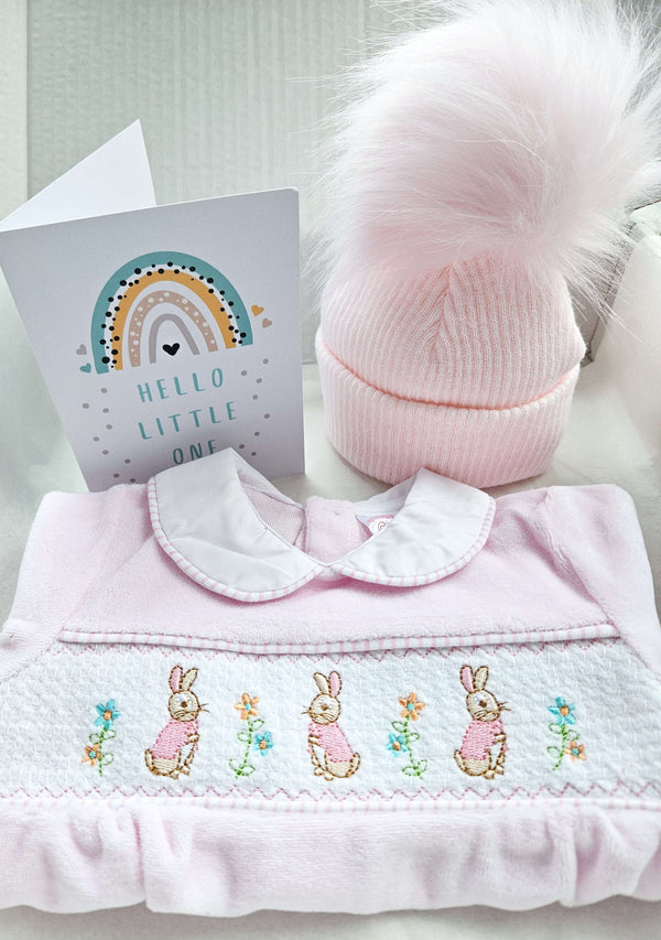 Baby Girl Velour Gift Box: Featuring Velour Pink Floral Bunnies Sleepsuit:, a cosy Pink Single Pom Pom hat, and a sweet New Baby card, this luxurious gift set is perfect for welcoming a baby Girl into the world.