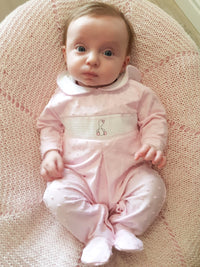 Baby wearing pink duck detail sleepsuit