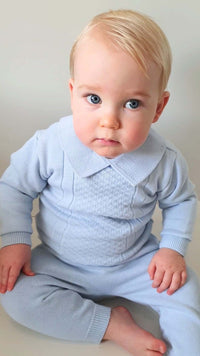 Close up of knitted pullover baby set